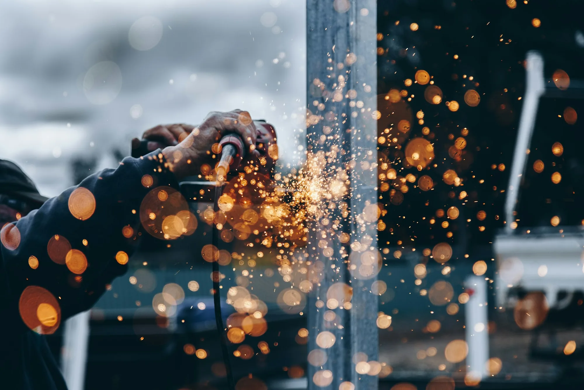 Sparks flying from metal grinding in an industrial workshop